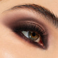 Smoky taupe, chocolate, and plum shadows blended across lid and lower lash line, showcasing the After Hours Shadow Palette, a ColourPop Shadow Palette, on a close-up eye with full lashes for an evening glam look.