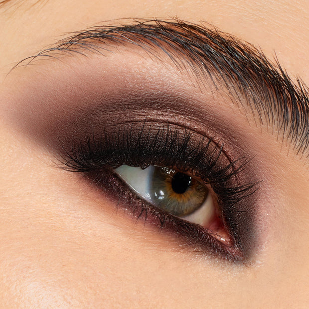 Smoky taupe, chocolate, and plum shadows blended across lid and lower lash line, showcasing the After Hours Shadow Palette, a ColourPop Shadow Palette, on a close-up eye with full lashes for an evening glam look.