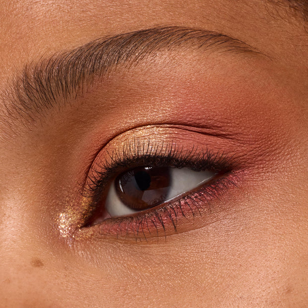 Close-up eyelid showcases peachy-gold shimmer and soft coral mattes from the Baby Got Peach ColourPop Shadow Palette, with metallic inner-corner pop and smoked peach lower lash line for a warm, wearable summer eye look.