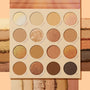 Golden Hour ColourPop Shadow Palette displaying 16 warm neutrals - champagne, caramel, copper, and deep brown to charcoal - in matte and shimmer finishes, with shade names around each pan and matching swatches beside it on a peach backdrop.