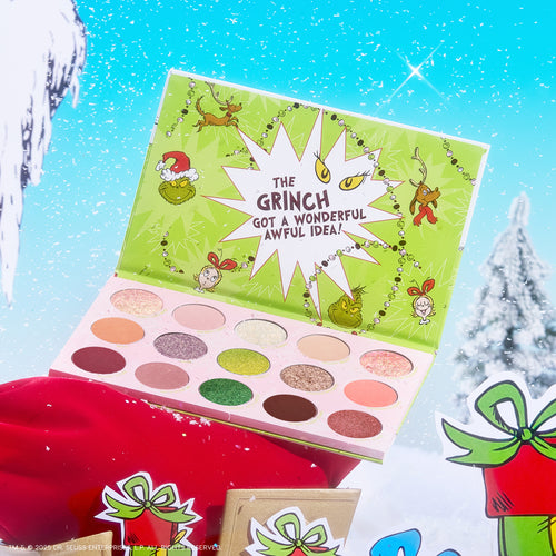 Colourpop How the Grinch Stole Christmas shadow palette opens to show matte and shimmer greens, pinks, and neutrals in festive Grinch artwork, staged on a snowy holiday scene with gifts.