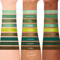 Three forearms display swatches of the ColourPop Shadow Palette Just My Luck, a monochrome green edit of nine shades - Chances Are…, Kiss My Hass, So-So, Big Banks, Mary Jane, Olive U, Act Natural, Too Matcha, Charmed - in matte and metallic finishes.
