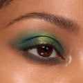 Eyelid showcasing a metallic lime-to-emerald green gradient from the Rainbow Rush Shadow Palette Set, ColourPop green eyeshadow look, with soft mascara and a defined brow in a tight close-up.