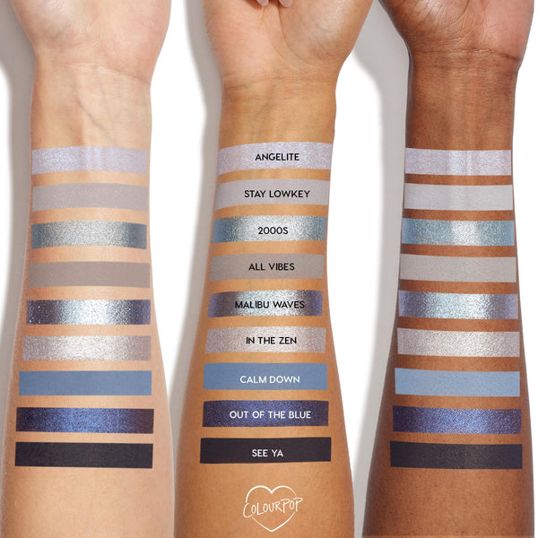 Three arms show swatches of the So Elemental ColourPop Shadow Palette, 12 cool‑toned shades in shimmer and matte - from lilac and icy silver to teal, cobalt, navy, and black - with shade names (Angelite to See Ya) labeled on the center arm.