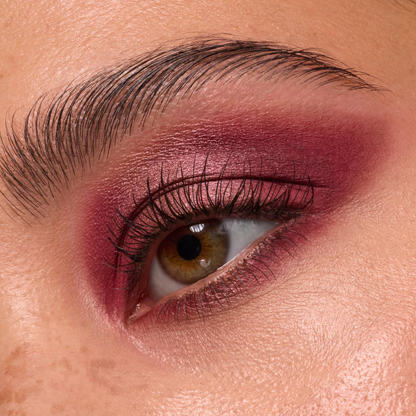 Close-up eye wears deep wine and rose shimmer shadow, lashes softly defined, showcasing ColourPop Wine and Only shadow palette with burgundy mattes and metallics blended across lid and crease for a smoky finish.