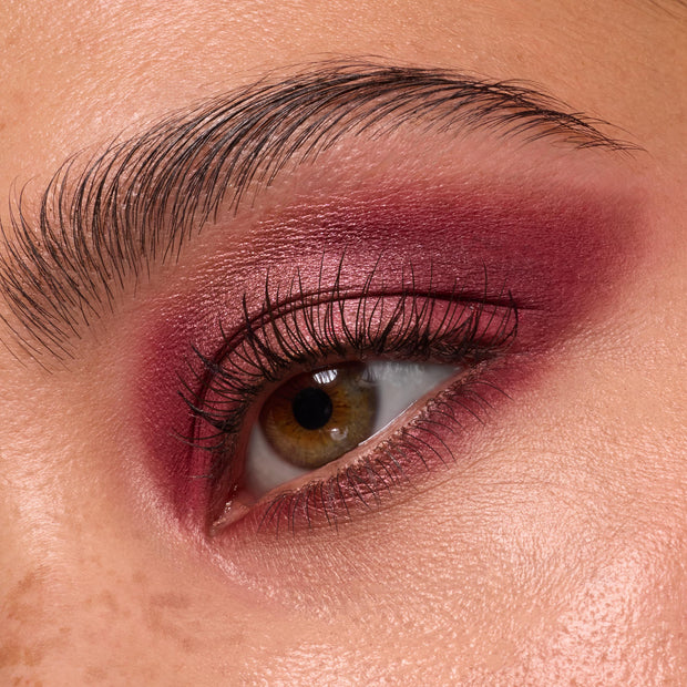 Close-up eye wears deep wine and rose shimmer shadow, lashes softly defined, showcasing ColourPop Wine and Only shadow palette with burgundy mattes and metallics blended across lid and crease for a smoky finish.
