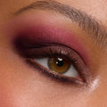 Close-up hazel eye wears a deep berry and plum smoky blend with soft shimmer and inner-corner highlight, created using A Shadow of Secrets Shadow Palette, a ColourPop Shadow Palette, showing bold pigment and smooth blend on lid and lower lash line.