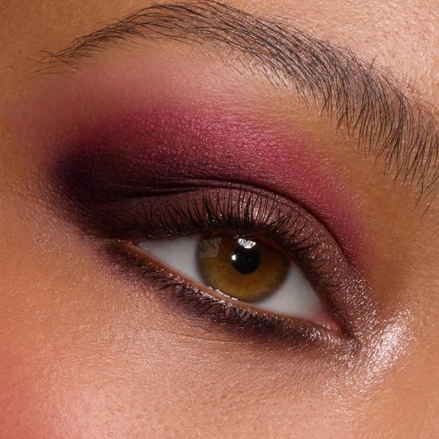 Close-up hazel eye wears a deep berry and plum smoky blend with soft shimmer and inner-corner highlight, created using A Shadow of Secrets Shadow Palette, a ColourPop Shadow Palette, showing bold pigment and smooth blend on lid and lower lash line.