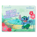 Beach Dreamin’ ColourPop Shadow Palette featuring mint-green packaging with a holographic title and Disney Lilo & Stitch art - Stitch dancing in a grass skirt against a Hawaiian beach scene with palms, hibiscus, and star accents.
