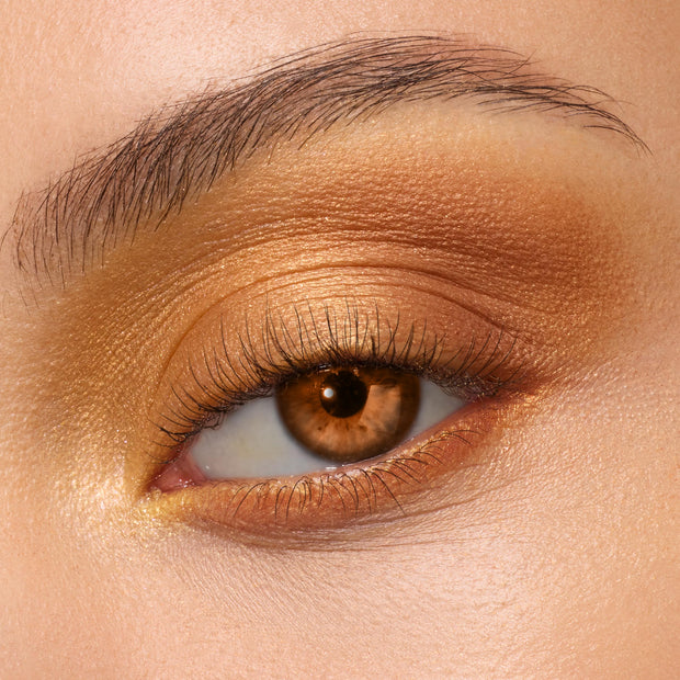 Golden amber shimmer eyeshadow on a brown eye, metallic gold on the lid, warm bronze in the crease, and soft highlight at the inner corner, showcasing the New Moon Shadow Palette, a ColourPop Shadow Palette.