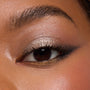 Metallic eye makeup featuring a shimmery champagne lid, bronze crease, smoky outer corner, and gold lower lash line, created with the ColourPop Precious Metals Shadow Palette; close-up showcases pigment, shimmer, and defined lashes.