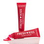 Cherry Glaze ColourPop Fresh Kiss Glossy Balm oozing from a slanted applicator and pooling in bright cherry-red gloss, with a second red squeeze tube standing upright behind on a clean, reflective white background.