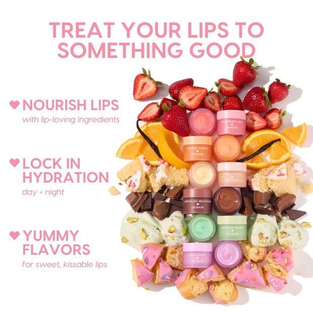 Orange Vanilla Lip Mask jar anchors a vertical stack of pastel lip mask pots, surrounded by fresh strawberries, orange wedges, vanilla bean, cake, chocolate chunks, pistachio gelato, and jelly donut bites, highlighting the ColourPop Lip Care Kit in a bright flat lay.