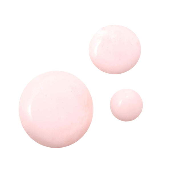 Strawberry Face Milk swatches pooling as three glossy, light pink droplets on a white background, showcasing the creamy texture and dewy finish of the ColourPop Face Milk.