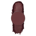 Facet pressed powder shadow by ColourPop, a round single pan in deep burgundy plum, shown with a vertical swatch and soft crumbled edges on a white background.
