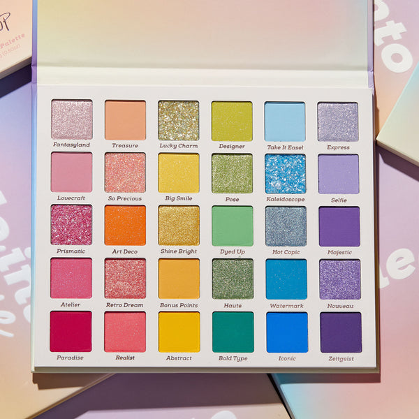 ColourPop Shadow Palette Fade Into Hue opened to display 30 rainbow eyeshadows in matte, shimmer, and pressed glitter finishes, from pinks and oranges to greens, blues, and purples, each shade labeled in a 5x6 grid, set on a pastel box background.