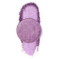 ColourPop Pressed Powder Shadow in Fluff, a single-pan lilac-purple shimmer eyeshadow, resting over a crushed, sparkly swatch on a clean white background to showcase its high-pigment, glittery finish.
