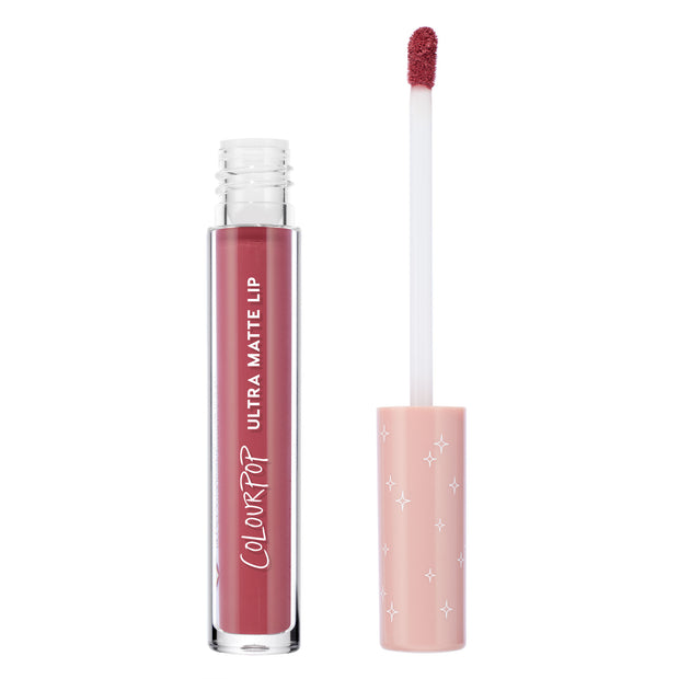 ColourPop Flurries Ultra Matte Lip liquid lipstick stands open with a doe-foot applicator coated in dusty rose mauve, beside a clear tube with white ColourPop branding and a blush pink cap with white star print on a white background.