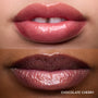 Close-up swatches of Colourpop Fresh Kiss Glossy Balm in Chocolate Cherry on two lip tones, showing sheer berry shine with subtle shimmer, promoting Lip Gloss & Lip Oil finish and smooth, hydrated lips.