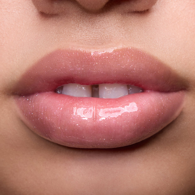 Close-up of models’ lips wearing Colourpop Fresh Kiss Glossy Balm in Raspberry Crème, showing sheer pink shimmer Lip Gloss & Lip Oil finish on different skin tones against a simple studio background.