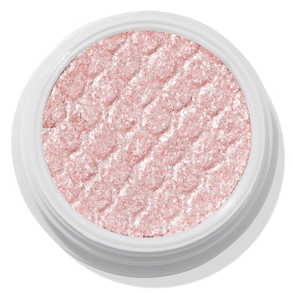 ColourPop Frog Super Shock Shadow shimmering in a white round pot, a pale pink‑champagne cream‑to‑powder eyeshadow with silver sparkle and a bouncy, textured finish, shown close up on a clean studio background.