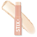 Glazey ColourPop Lite Stix highlighter stands uncapped, showing a champagne‑pearl cream stick with a wide swatch behind, housed in a blush‑pink tube labeled STIX and ColourPop against a white background.