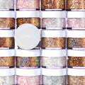 Ur A Firework ColourPop Glitter Gel jar shining with holographic sparkle, resting on stacked white-lidded pots, showcasing the Glitterally Obsessed collection in a bright studio setting with multicolor glitter visible through clear sides.