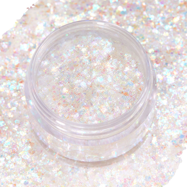 Clear jar of Disco Lady Glitter Gel shimmering with iridescent, chunky opal flakes, open to show texture, sitting on a wide swatch of matching sparkle on white; ColourPop Glitter Gel for face and body festival makeup.