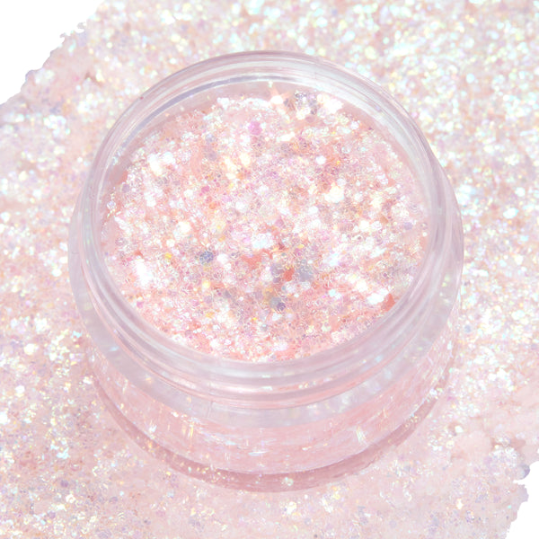 Open jar of So Cute ColourPop Glitter Gel shimmering with chunky iridescent pink and opal flecks, resting on a dense swatch of the same sparkle on white, highlighting the translucent gel base and high-shine finish.