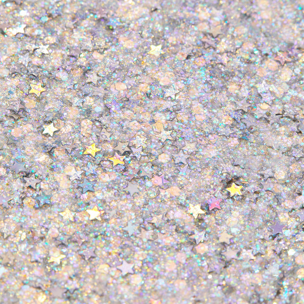 Ur A Firework Glitter Gel shimmering in a macro swatch, packed with iridescent hex glitter and metallic star sequins on a cool lavender base, reflecting rainbow hues; ColourPop Glitter Gel texture close-up.