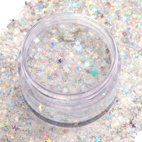 Open clear jar of Ur A Firework ColourPop Glitter Gel displaying a chunky‑fine mix of silver iridescent glitter and pastel holographic star confetti shimmering in a clear base, set atop a swatched bed of matching sparkle for face and body looks.