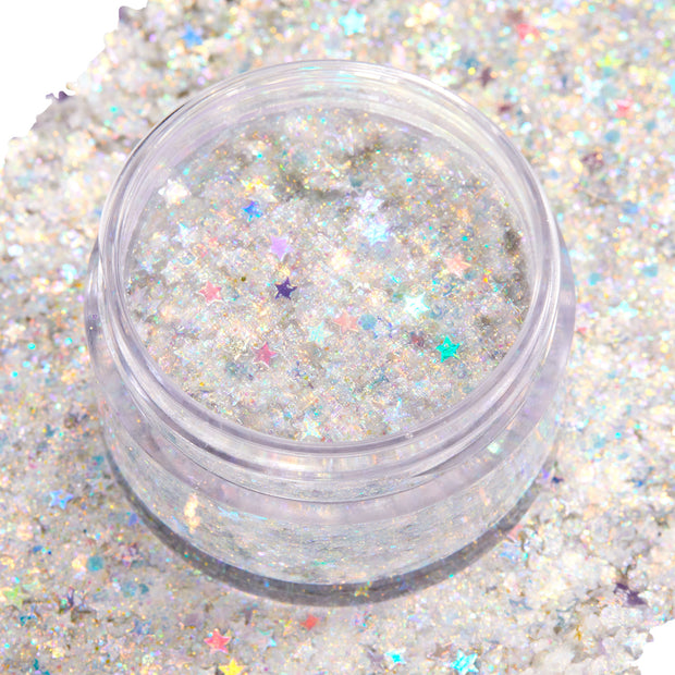 Open clear jar of Ur A Firework ColourPop Glitter Gel displaying a chunky‑fine mix of silver iridescent glitter and pastel holographic star confetti shimmering in a clear base, set atop a swatched bed of matching sparkle for face and body looks.