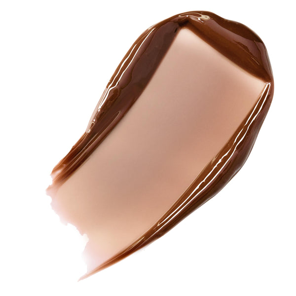 Chocolate Milkshake shade of ColourPop Fresh Kiss Glossy Balm swatched in a single thick stroke, revealing a sheer milky cocoa-brown tint with a high-shine, smooth texture on a white studio background.