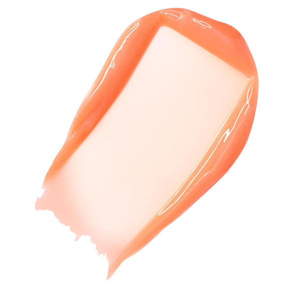 Peachy mango-coral swatch of ColourPop Fresh Kiss Glossy Balm in Mango Sorbet, swept in a thick, high-shine stroke on a white background, highlighting its sheer tint, glossy finish, and smooth, cushiony texture.