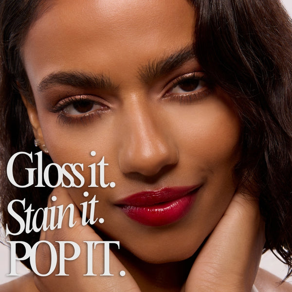 Baby Fox lip stain adding glossy, deep cherry-red color to a model’s lips, showing a high-shine, lightweight finish in a tight beauty close-up; ColourPop Lip Stain highlights rich pigment and a smooth, hydrating look for everyday wear.