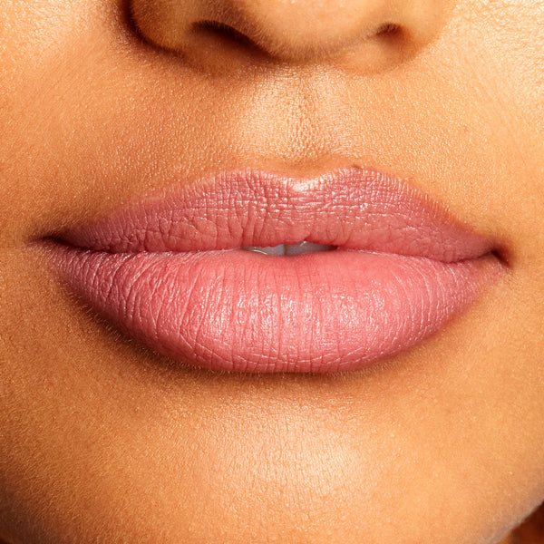 Soft mauve-pink lips lined and filled with the Good N Plenty shade, highlighting the creamy, satin finish and crisp edges of the ColourPop Lippie Pencil in a tight close-up of the mouth against natural skin.