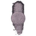 Goody Two-Shoes pressed powder shadow by ColourPop - shimmery gunmetal-lilac eyeshadow pan - rests over a vertical swipe of crushed pigment, showcasing its metallic sparkle on a clean white background.