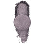 Goody Two-Shoes pressed powder shadow by ColourPop - shimmery gunmetal-lilac eyeshadow pan - rests over a vertical swipe of crushed pigment, showcasing its metallic sparkle on a clean white background.