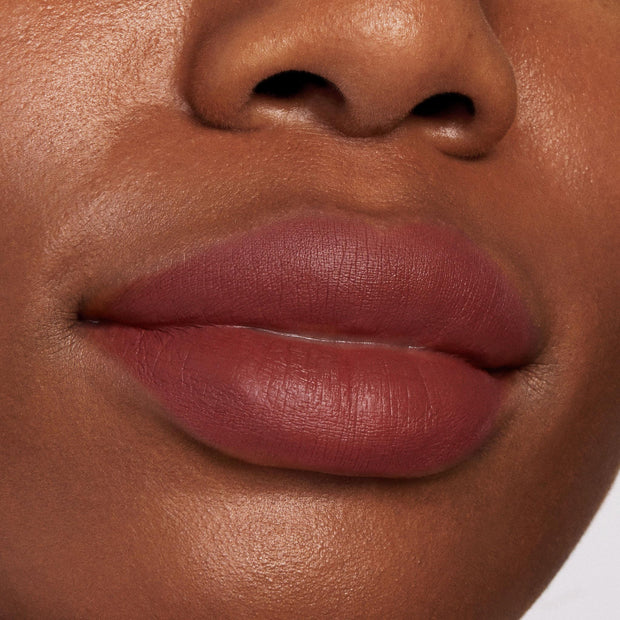 Full lips wearing Grunge, a ColourPop Lippie Pencil lip liner, lining and filling the lips in a matte rose-brown shade; close-up beauty shot highlighting smooth, precise edges and velvety texture.