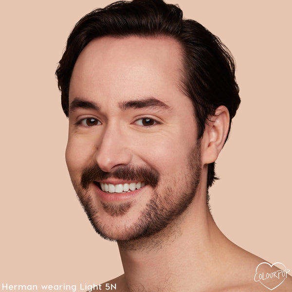 Model with a light neutral complexion wearing Light 5 N shows even, natural coverage from the ColourPop Pretty Fresh Tinted Moisturizer; close-up smile against a soft beige backdrop highlighting smooth, hydrated skin.