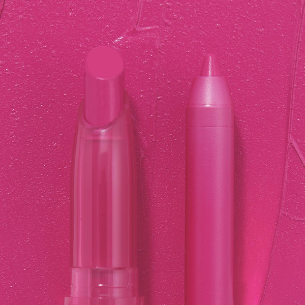 Heart Lips ColourPop Lippie Stix + Pencil Set standing side by side, the rounded stix and pointed liner displayed against a creamy hot-pink swatch background, showcasing the bold fuchsia shade for precise lining and full-color fill.