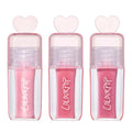 Three ColourPop Gloss Me Up ultra glossy lip set tubes from the Heart to Get collection standing upright, each in a clear pink case with heart-shaped cap and varying pink gloss shades on a clean white background.