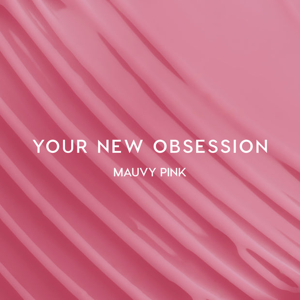 Heart to Get Sorry Not Sorry blush + UGL set swatched in smooth mauvy pink stripes, showing creamy, highly pigmented color payoff against a glossy pink background for modern US makeup lovers.