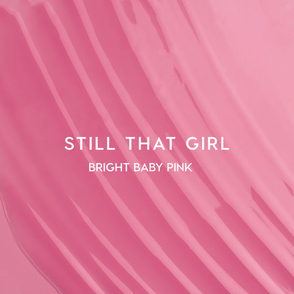 Still That Girl Ultra Glossy Lip Heart to Get swatch showing smooth, bright baby pink lip gloss spread in soft ridges across a solid pink background, highlighting its high-shine, creamy texture for bold, glossy lips.