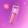 ColourPop Your New Obsession ultra glossy lip in the Heart to Get shade floats diagonally against a glowing pink and purple background, clear tube and heart-shaped cap highlighting the high-shine pink gloss for a dreamy makeup look.