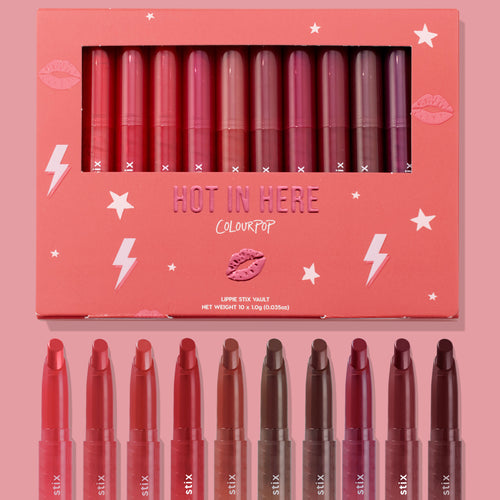 Hot in Here ColourPop Lippie Stix vault showcasing 10 creamy shades - from rosy pinks and corals to berries and deep browns - arranged in a coral box with star and lightning graphics, windowed lid, and matching bullet tips displayed below.