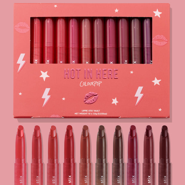 Hot in Here ColourPop Lippie Stix vault showcasing 10 creamy shades - from rosy pinks and corals to berries and deep browns - arranged in a coral box with star and lightning graphics, windowed lid, and matching bullet tips displayed below.