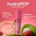 Baby Fox ColourPop Lip Stain hydraPOP glossy tube, beaded with dew, stands among fresh guava and lychee on a pink backdrop, highlighting guava + lychee extracts and a weightless water-based, hydration-infused color in vibrant pink.