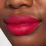 Lips wearing ColourPop Lippie Pencil I Heart This, a vivid hot pink-red lip liner defining and filling lips with a smooth matte finish in a studio close-up.
