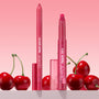 Ultimate Lip Combo showcases a pink-red ColourPop Lippie Stix + Pencil Set: lippie pencil and lippie stix standing upright with translucent pink caps, framed by fresh cherries against a soft pink gradient backdrop.